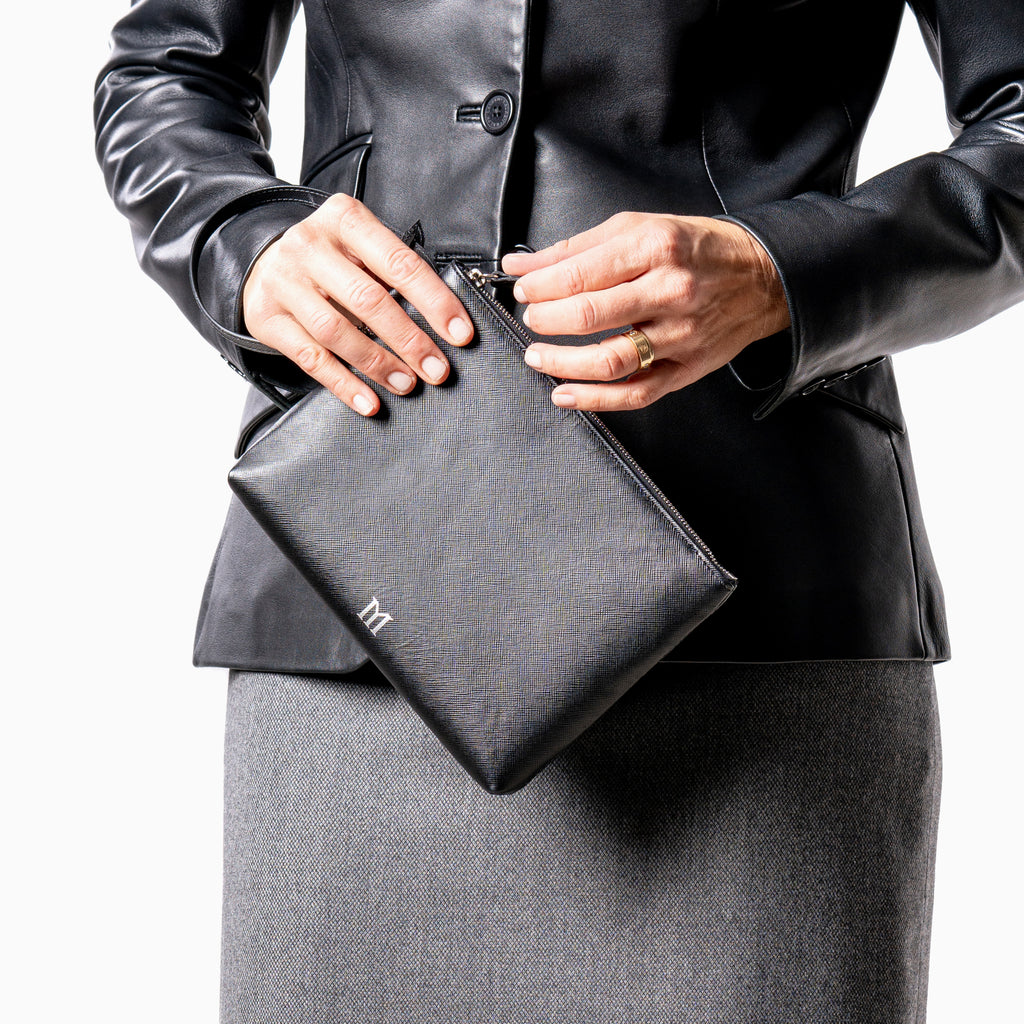 Woman holding Maison Marrain DeuxVie small black leather pouch