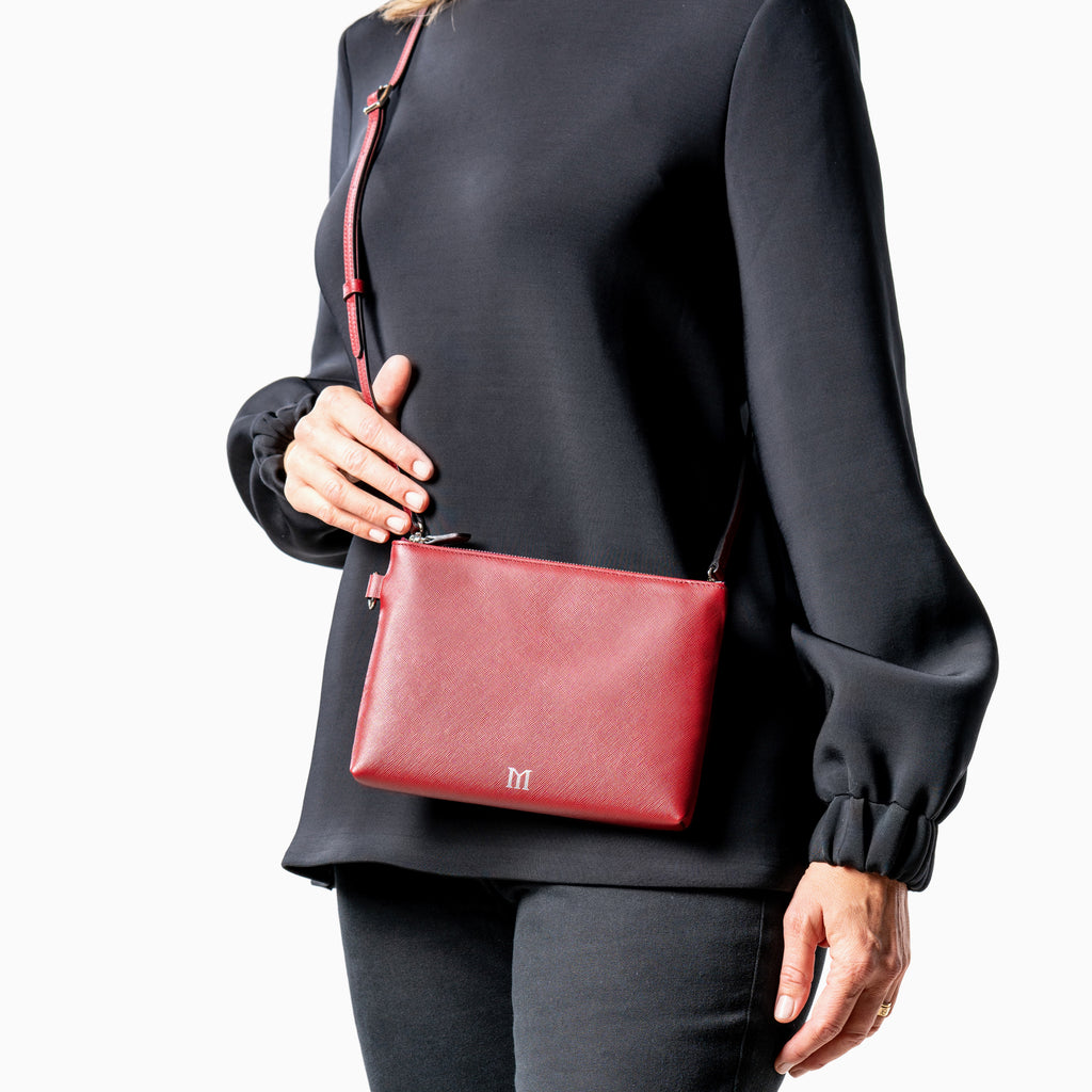 woman in black with crossbody strap Maison Marrain DeuxVie small leather red Bordeaux pouch 