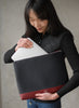 Asian woman placing ipad inside the DeuxVie Neoprene big pouch in bordeaux red 