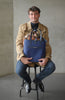 Man holding the DeuxMag All Weather big neoprene and leather blue Tote bag 
