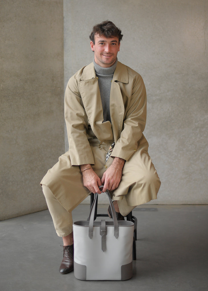 Man holding the DeuxMag All Weather big neoprene and leather taupe and grey Tote bag 