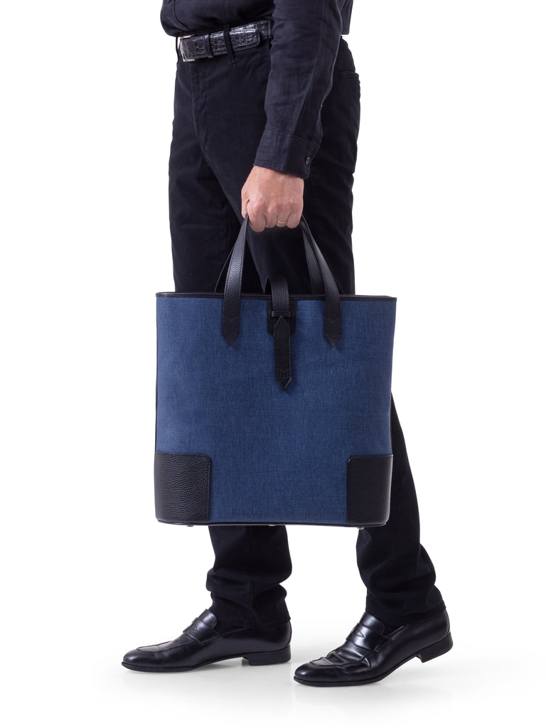 Man holding DeuxMag  big canvas and leather blue marine and black Tote bag 