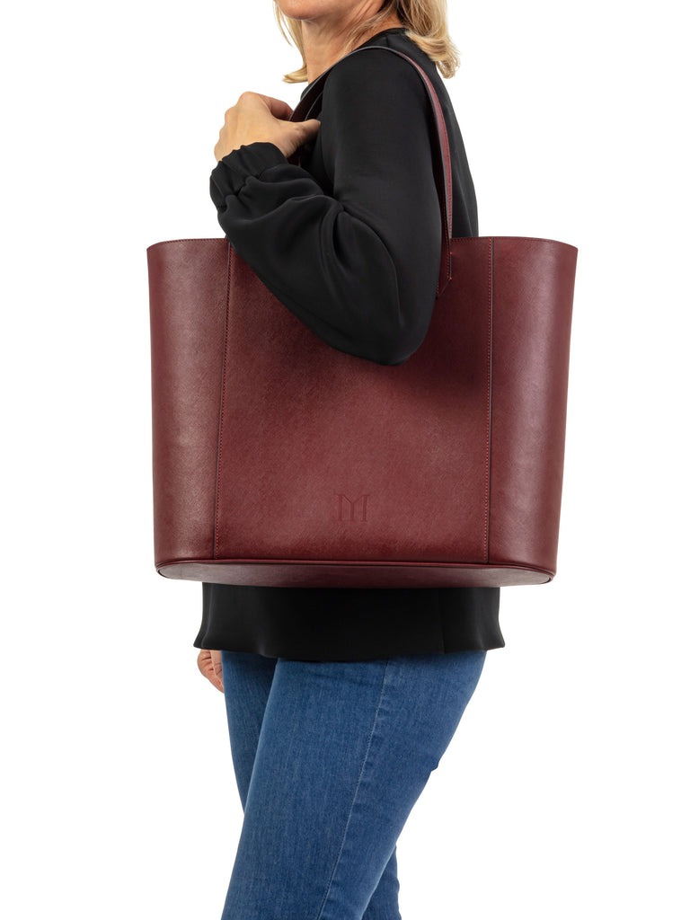 womand holding Maison Marrain DeuxVin leather tote Bag in red bordeaux 