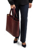 woman on high heels holding Maison Marrain DeuxVin leather tote Bag in red bordeaux