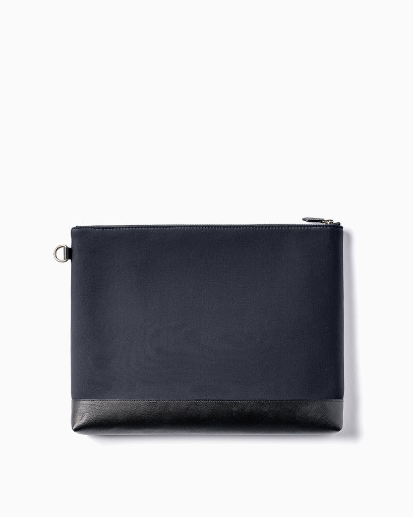 Back of Maison Marrain deux vie large black pouch for laptop or documents made from neoprene with durable leather trim in black